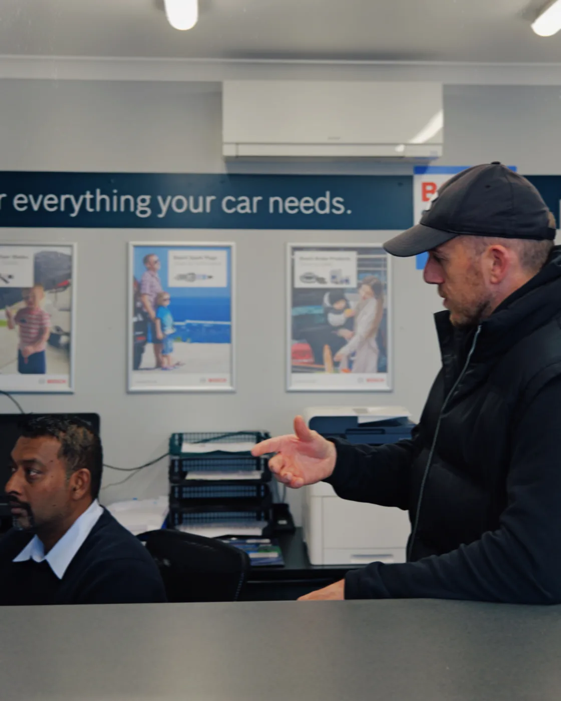 David Baker talking through a business system with a client at the service counter