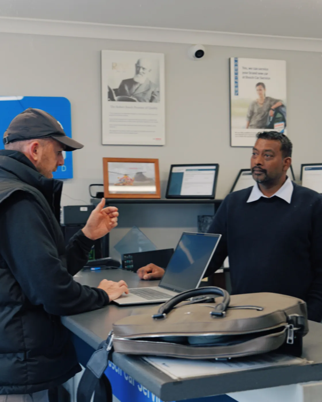 David Baker in a working session with a client at the front desk